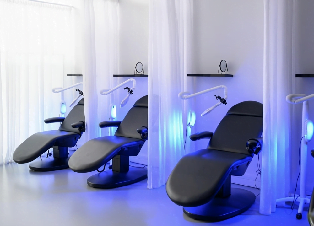 The UpWhiten treatment bays, curtained and lit blue by the whitening lamps.